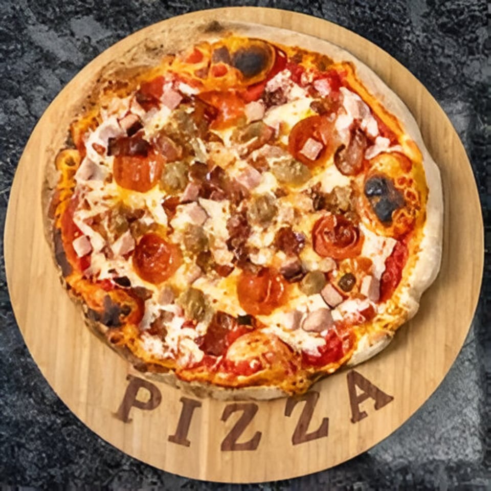 Bella Ciao's meat lover's pizza with pepperoni, sausage, and ham on a wooden board.
